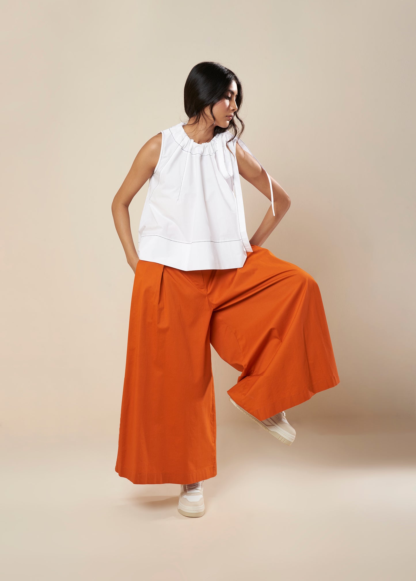 SLEEVELESS FLARE TOP WITH CONTRAST STITCH AND SIDE TIE