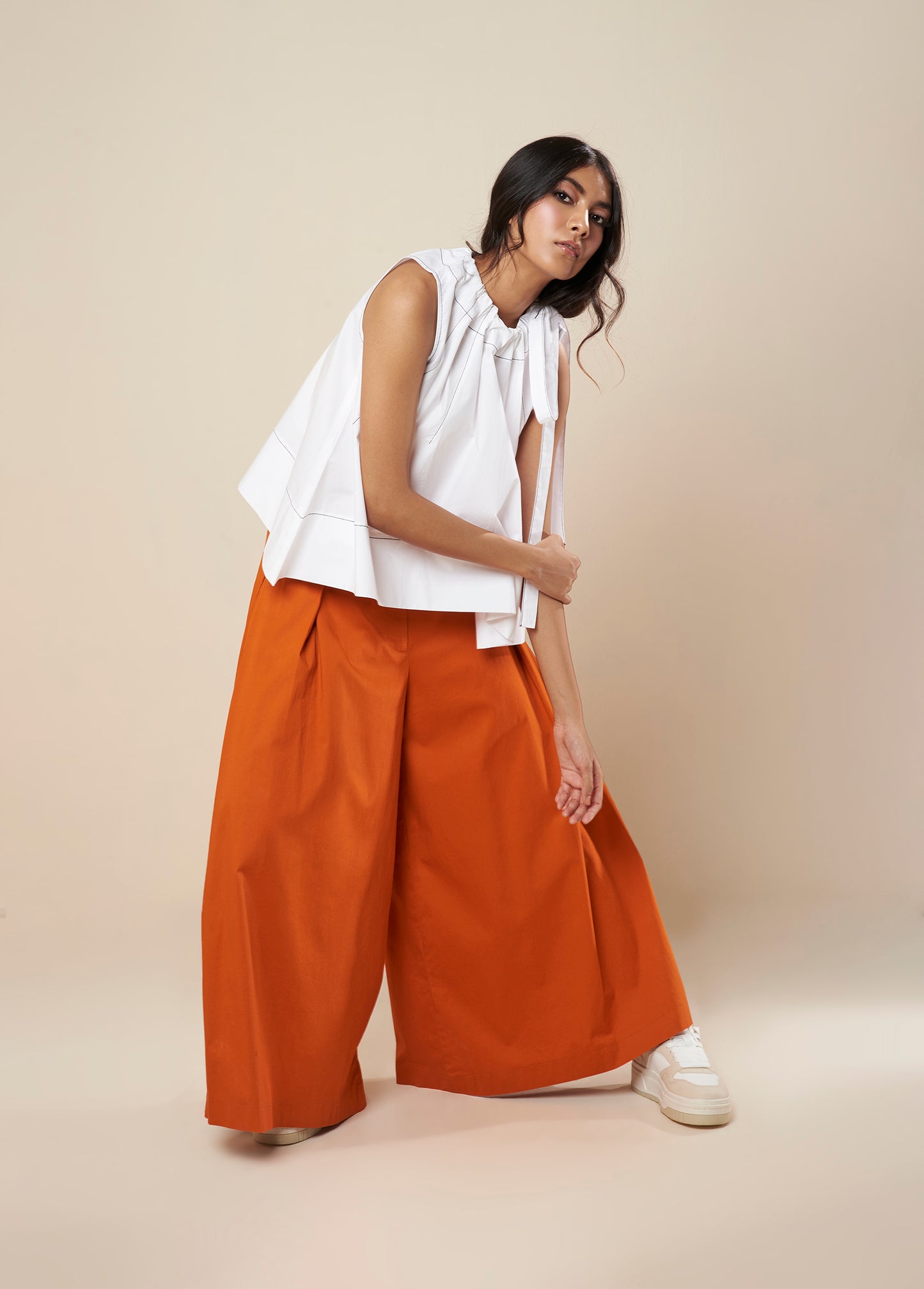 SLEEVELESS FLARE TOP WITH CONTRAST STITCH AND SIDE TIE