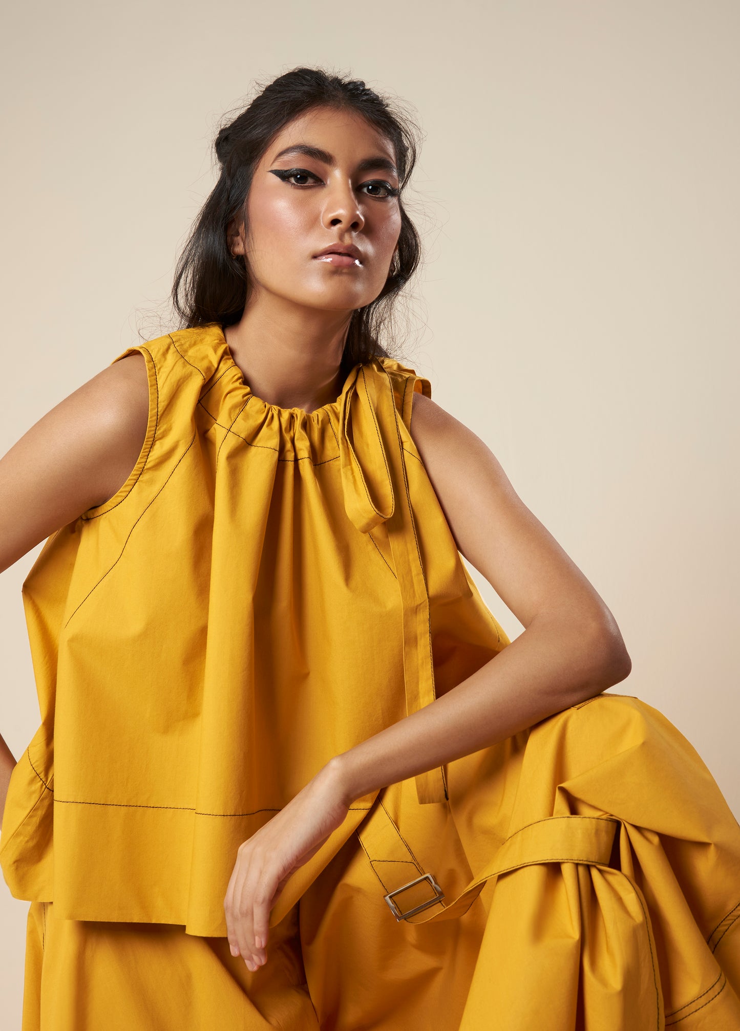 SLEEVELESS FLARE TOP WITH CONTRAST STITCH AND SIDE TIE