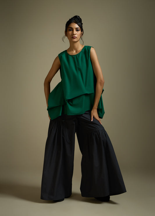 SLEEVELESS TOP WITH PANELLED DRAPE HEM