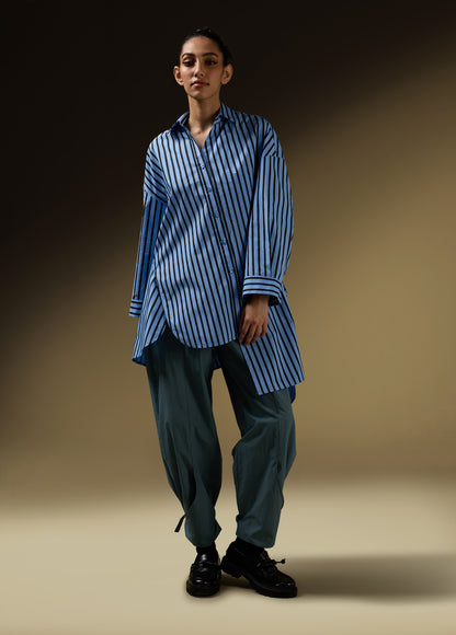 SHIRT WITH UNEVEN ASYMMETRICAL BUTTONTING AND BACK PLEATS