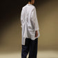 SHIRT WITH UNEVEN ASYMMETRICAL BUTTONTING AND BACK PLEATS