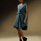 SLEEVELESS DRESS WITH ASYMMETRICAL FRONT PLEAT AND SHOULDER PADS