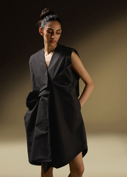 SLEEVELESS DRESS WITH ASYMMETRICAL FRONT PLEAT AND SHOULDER PADS